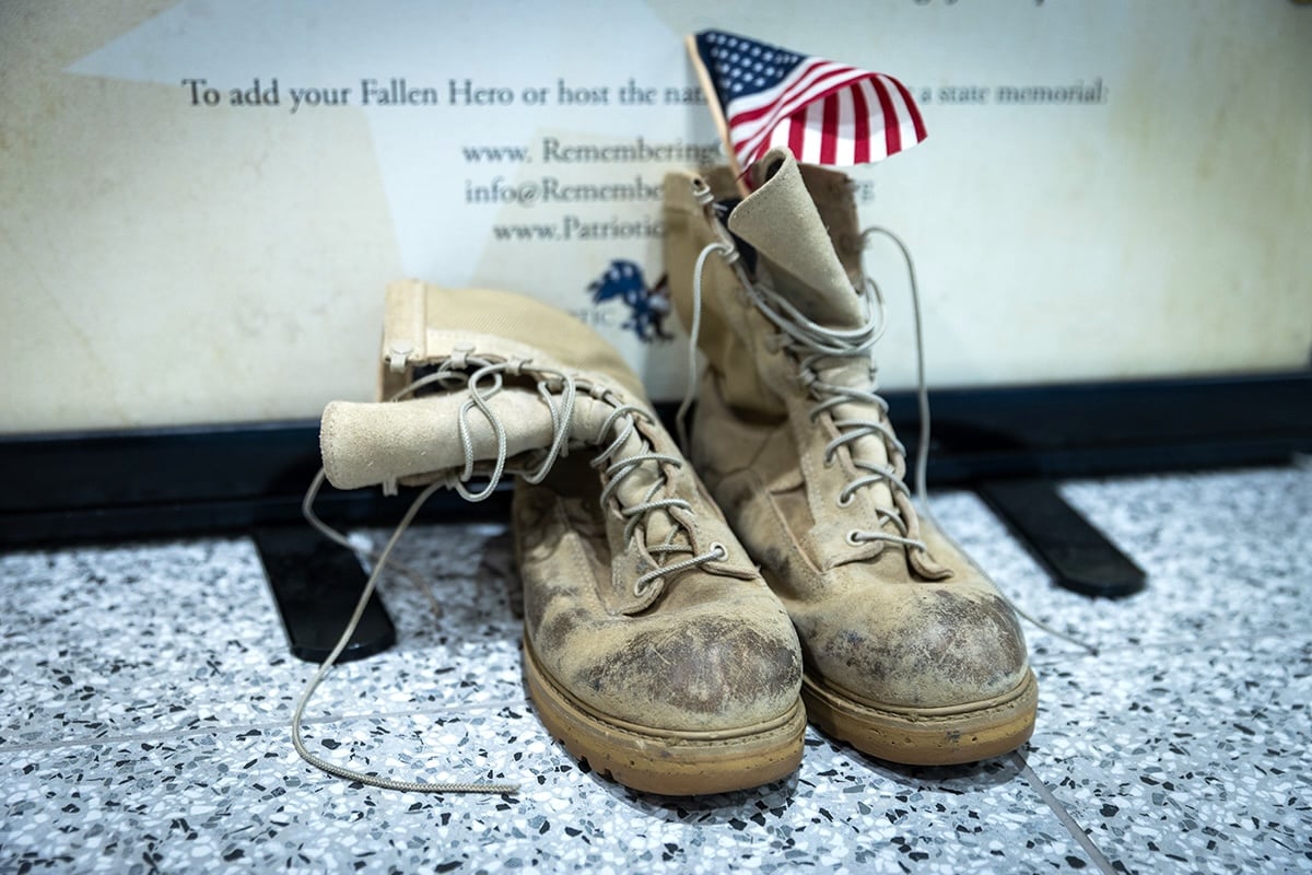 Military boots with an American flag in them, left in memory of lives lost.